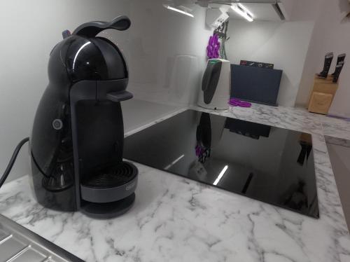 a coffee maker sitting on top of a kitchen counter at QnQ home in Helsinki