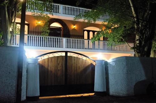 a fence in front of a house at night at Murphy's Transit Villa Airport Pick & Drop Katunayake in Katunayake