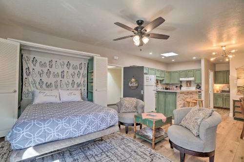 a bedroom with a bed and two chairs and a kitchen at Williams Studio on Famous Route 66 with Fireplace! in Williams
