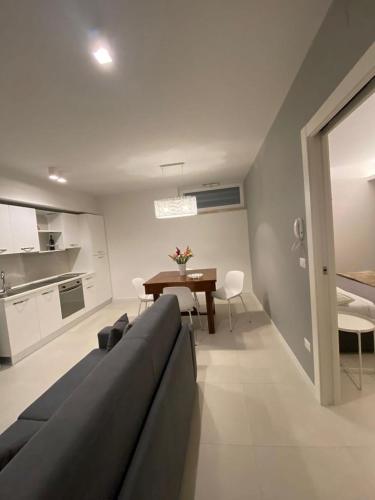 a living room with a couch and a table at MATE' APARTMENTS - FREE WIFI & AIR CONDITIONAL - Molfetta, Puglia, Italy in Molfetta