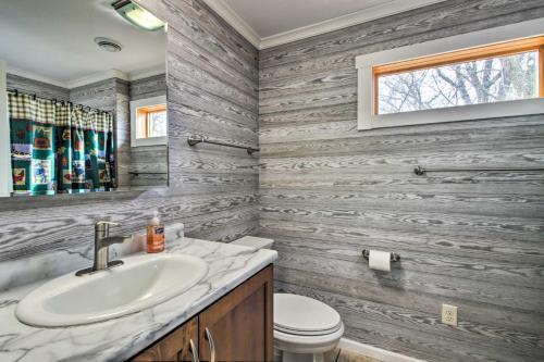 a bathroom with a sink and a toilet at Remote Retreat Cozy Home with Big Pine Lake Access! in Perham