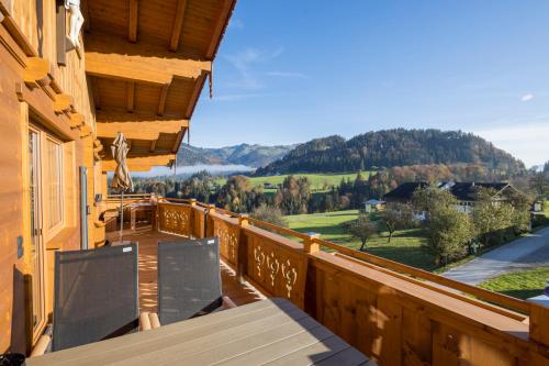 a wooden balcony with a view of the mountains at Erbhof Fritzing in Ebbs