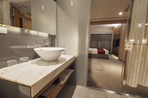 a bathroom with a sink and a bathroom with a bed at 立多精品旅館Li Duo Best Hotel in Taipei