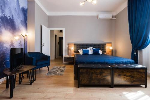 a bedroom with a bed and a desk and a television at Joy City Stay Piatra Craiului 8 in Timişoara