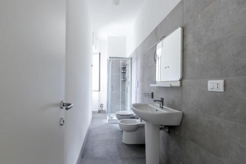 a bathroom with two toilets and a sink and a mirror at Top Living Apartments - Carducci in Turin