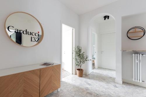 a white room with a mirror on the wall at Top Living Apartments - Carducci in Turin