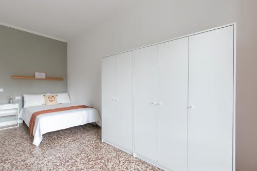 a bedroom with a bed and a large white cabinet at Top Living Apartments - Carducci in Turin