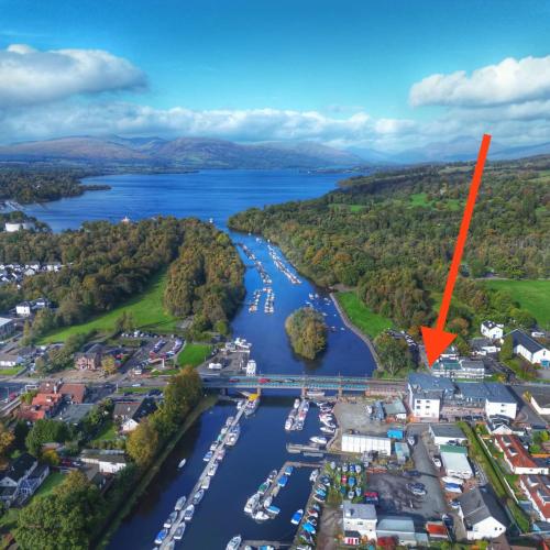 arial view of a marina with boats in the water at Riverside View Penthouse in Balloch, Loch Lomond in Balloch