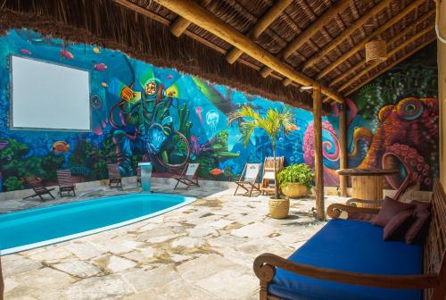 a room with a swimming pool and a mural at Longboard Paradise Surf Club in Rio de Janeiro