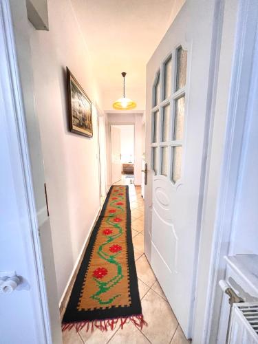 a hallway with a rug on the floor next to a door at "Epidavros" Apartment of Levidi Arcadian Apartments in Levidhion