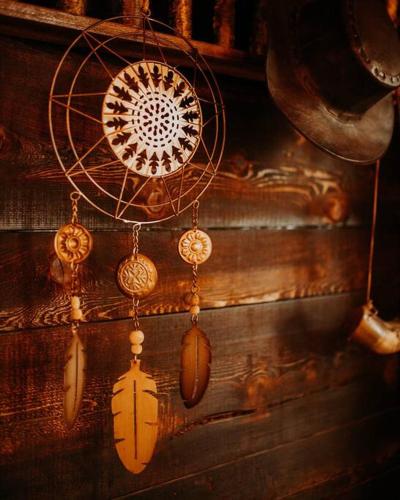 a group of ornaments are hanging on a wall at Treehouse on the Water -Eagles Nest-20 ft high in Port Angeles