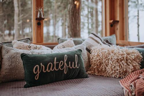 a group of pillows sitting on top of a couch at Treehouse on the Water -Eagles Nest-20 ft high in Port Angeles