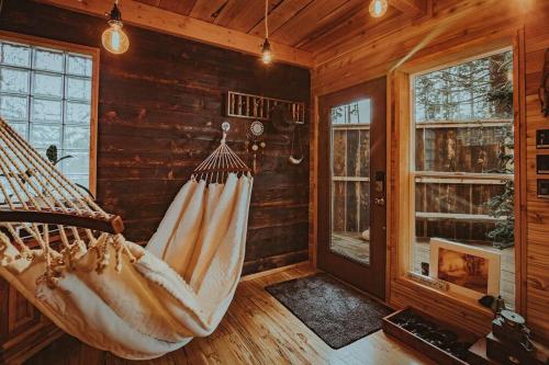 a room with a hammock in a log cabin at Treehouse on the Water -Eagles Nest-20 ft high in Port Angeles