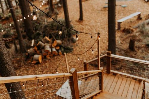 a wooden deck with string lights and a wooden bridge at Treehouse on the Water -Eagles Nest-20 ft high in Port Angeles