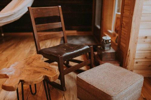 a wooden chair sitting in a room next to a log at Treehouse on the Water -Eagles Nest-20 ft high in Port Angeles
