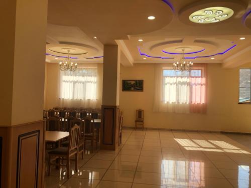 a banquet hall with chairs and a table and chandeliers at Liga Hotel and Restaurant in Shinuhayr