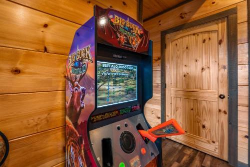 a video game arcade machine in a room at The Overlook - '21 Cabin - Gorgeous Unobstructed Views - Fire Pit Table - GameRm - HotTub - Xbox - Lots of Bears in Gatlinburg