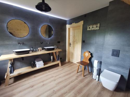 a bathroom with a sink and a toilet in a room at Predlówka - Na dachu Świata in Zawoja