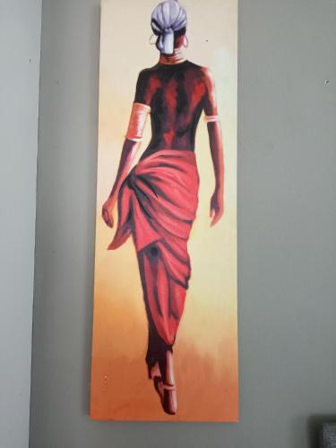 a painting of a woman walking on a wall at Menlyn Mews Guesthouse in Pretoria