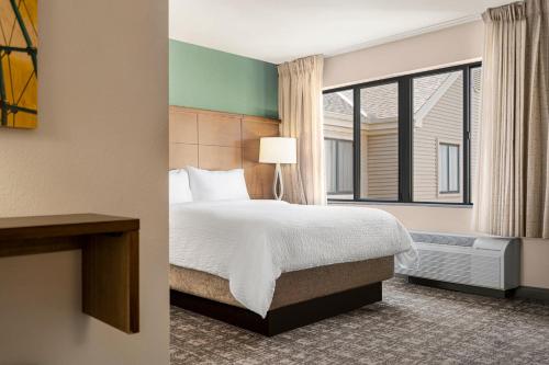 a hotel room with a bed and a window at Staybridge Suites Oklahoma City-Quail Springs by IHG in Oklahoma City