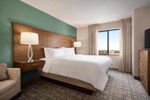 a hotel room with a bed and a couch at Staybridge Suites Oklahoma City-Quail Springs by IHG in Oklahoma City