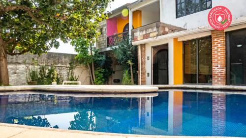 a house with a swimming pool in front of a building at Casa Madero in Oacalco