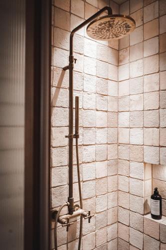 a shower in a bathroom with a tiled wall at Vocabolo Moscatelli in Calzolaro