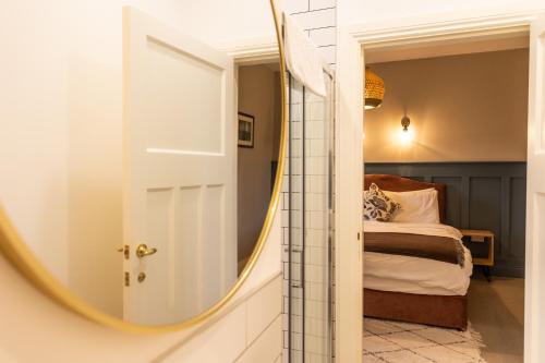 a mirror in front of a bedroom with a bed at Aiteall Bed and Breakfast in Liscannor
