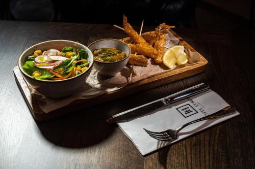 a tray with a plate of food on a table at HOTEL EUROPA in Komárno