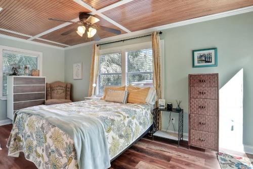 a bedroom with a bed and a ceiling fan at Palmettos Cabana in St. Augustine