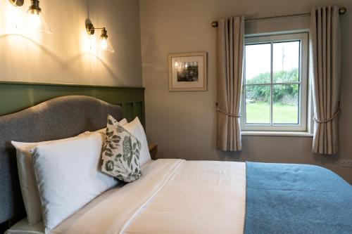 a bedroom with a bed and a window at Aiteall Bed and Breakfast in Liscannor