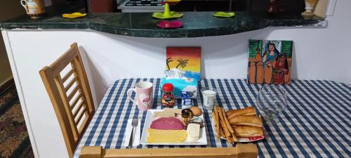 a table with a plate of food on it at Hotel apartment in Sheikh Zayed City in Sheikh Zayed