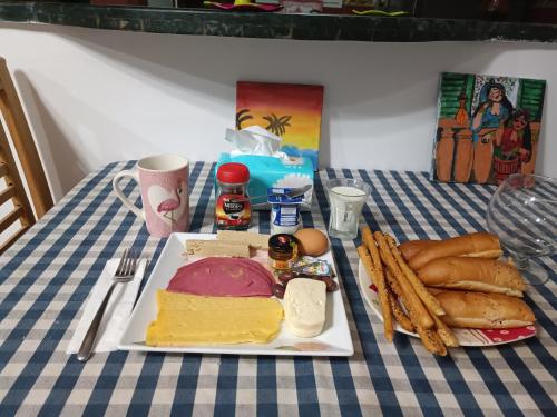 a plate of food on a table with bread and cheese at Hotel apartment in Sheikh Zayed City in Sheikh Zayed