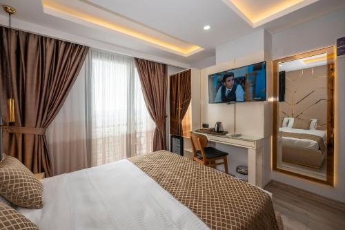 a hotel room with a bed and a desk at Luxury Airport Hotel By Zazzoni-İstanbul Airport in Arnavutköy