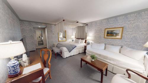 a bedroom with a bed and a living room at Avon Old Farms Hotel in Avon