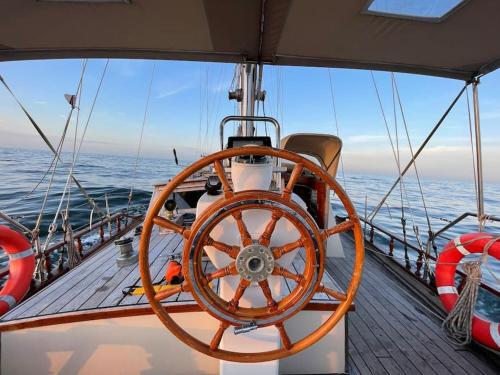 a large wooden wheel on the deck of a boat at Classic sailing ship in center of Enkhuizen! in Enkhuizen