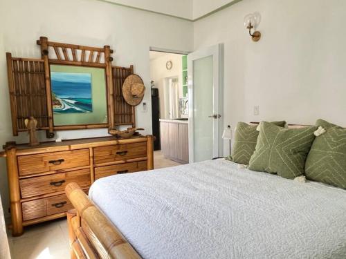 a bedroom with a bed and a dresser with a television on it at Casita Del Mar Oceanfront Romantic Retreat In Islote in Arecibo