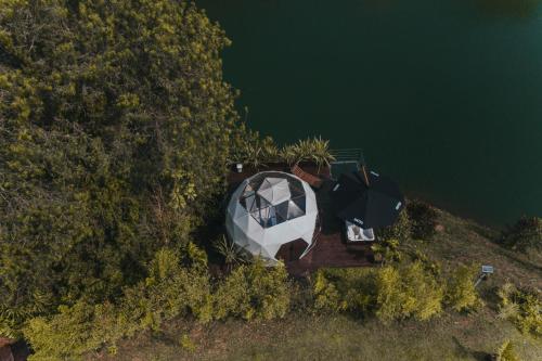 an aerial view of a boat on the water at Domus Glamping Guatapé in Guatapé
