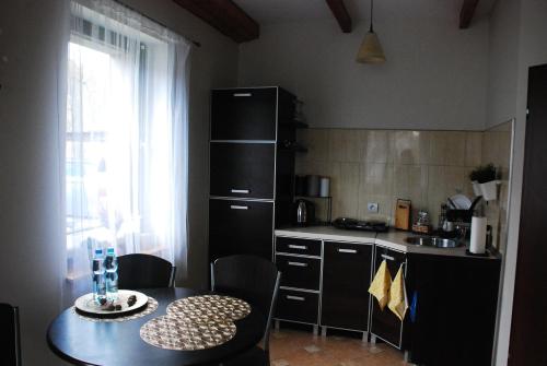 a kitchen with a table and a table and a window at Apartament u Waldemara in Łomnica