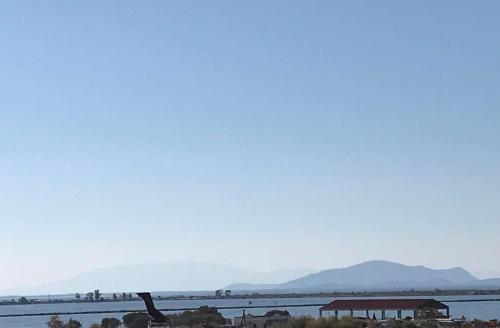 a view of a body of water with mountains in the background at Ion Apartments Messolonghi Double Room Sea View Loft in Mesolongion