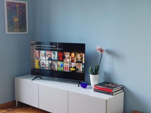 a tv sitting on top of a white cabinet at Casa Turati in Turin