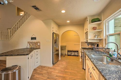 a large kitchen with a sink and a refrigerator at Modern Lake Conroe House with Lakefront Park and Deck! in Willis