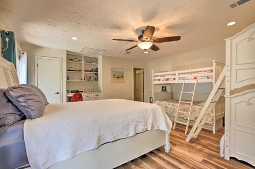a bedroom with a bed with a ceiling fan at Modern Lake Conroe House with Lakefront Park and Deck! in Willis