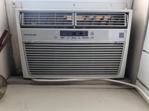 an air conditioner is sitting on the floor at Cozy Studio in Grand Junction