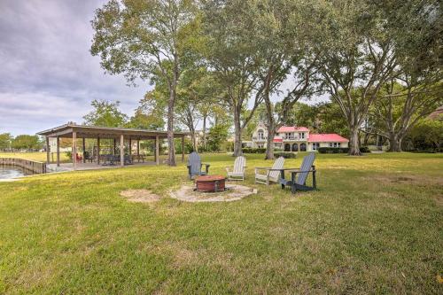 a park with benches and a pavilion in the grass at Modern Lake Conroe House with Lakefront Park and Deck! in Willis