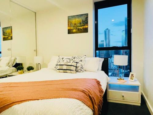 a bedroom with a large bed and a window at High Rise Unit in front of Crown with Free Parking in Melbourne