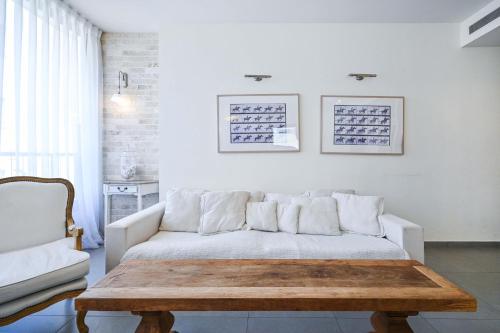 a living room with a couch and a coffee table at Hess st close to the beach by HolyGuest in Tel Aviv