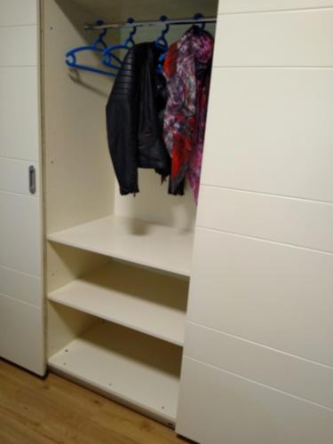 a closet with white walls and white shelves at Mi AN HOME in Paese