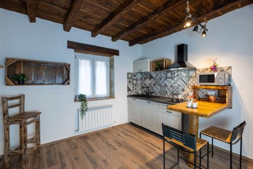 eine Küche mit einem Holztisch und einer Theke in der Unterkunft La Rosa del Borgo in Ancona