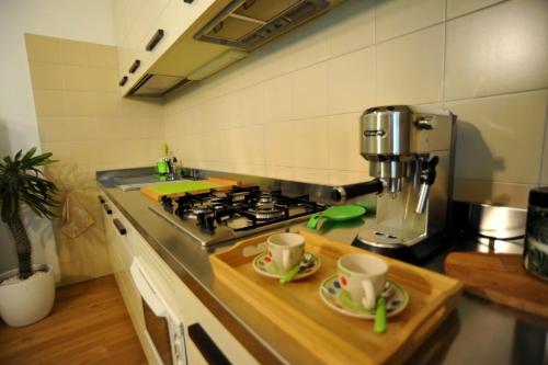 a kitchen with a stove and two cups on a counter at Mi AN HOME in Paese
